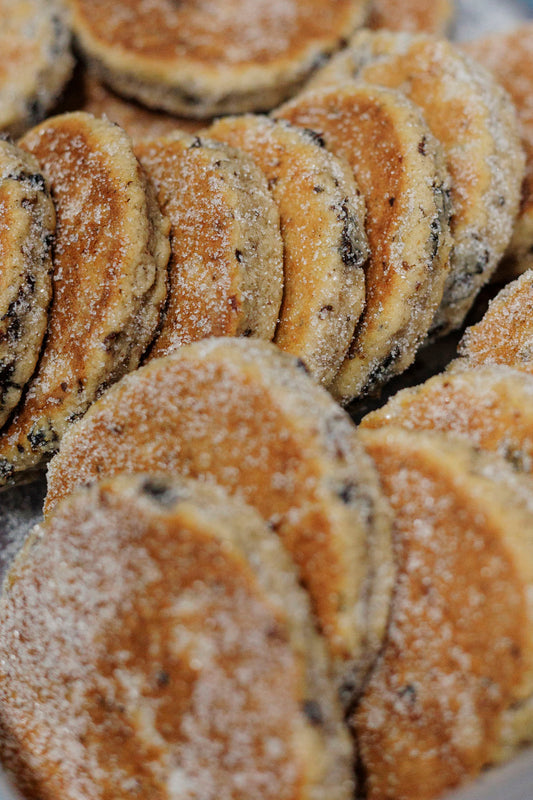 Close-up of a stack of Welsh cakes with a sugary coating.
